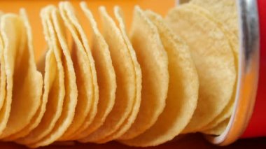 potato chips spilling form a packet on table ,