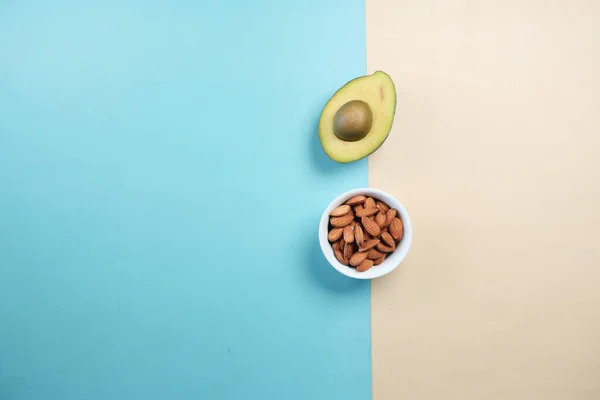 Top View Slice Avocado Almond Nuts Color Background — Stockfoto