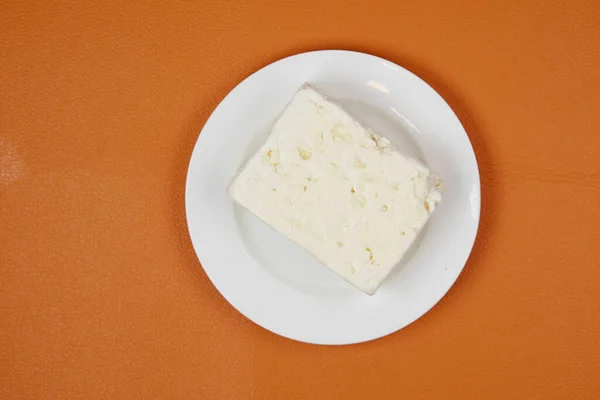 Feta Cheese Plate Orange Background — Zdjęcie stockowe