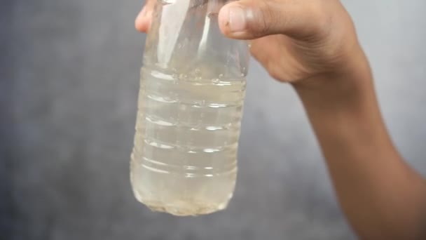 Holding Dirty Plastic Bottle Water Black Background — стоковое видео