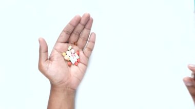 top view of mens hand taking medical pills.