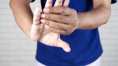 man suffering pain in fingers ,