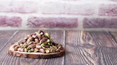 natural pistachios nuts in a wooden table ,