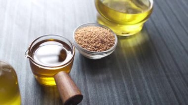 Mustard oil in a container on table .
