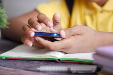  teenage boy using smart phone white sitting .