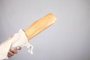 holding bag with bread on white color background.