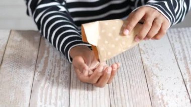 men eating mix nut sited on chair ,