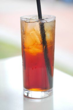  Iced tea in a misted glass on table ,