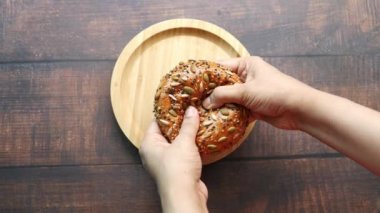 women holding sunflower seed baked bread ,