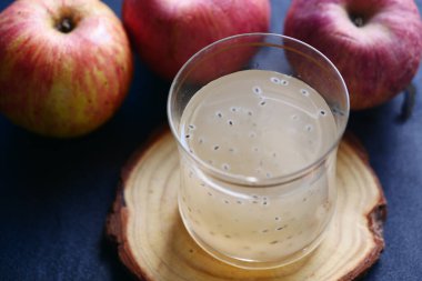 seed apple juice in a glass on table ,