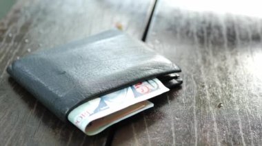  left wallet on a bench in the park ,