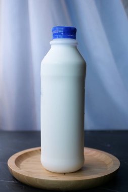 fresh milk in a plastic container on table ,