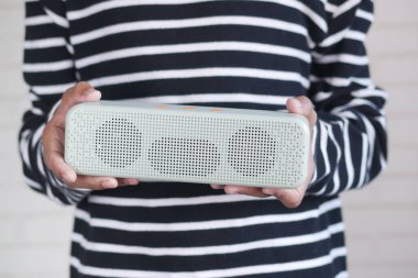 mans hand using smart speaker .