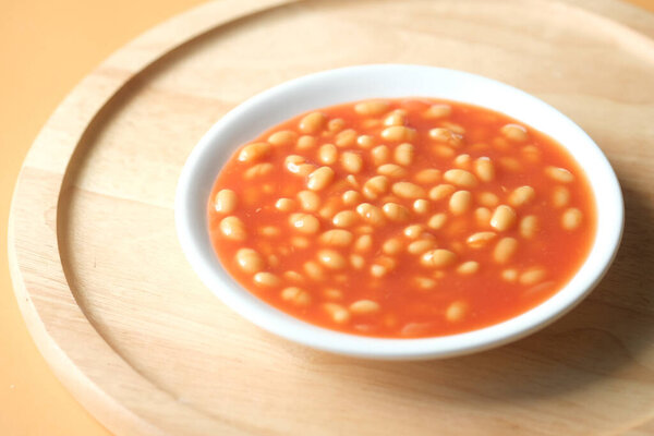 Tasty baked beans in a bowl on table ,