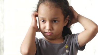 child girl teenage boy Scratching Head Against white background .,