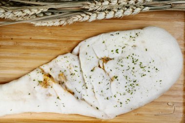 nan bread on a wooden board ,