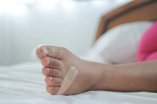 adhesive bandage on child feet on bed ,