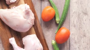  top view of raw chicken leg on a chopping board ,