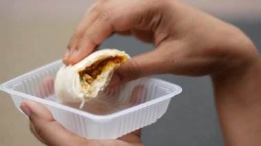  women eating chicken warp close up .