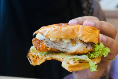 women hand holding beef burger top view ,