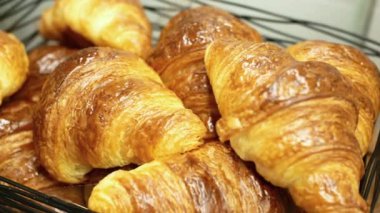 many fresh baked croissant in a bucket on table ,