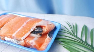 Raw, fresh salmon steak on a plastic packet on table ,