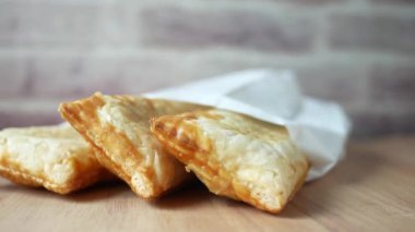 slice of apple pie cake in a take away packet on table ,