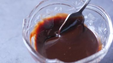 spoon pick dark chocolate on table ,