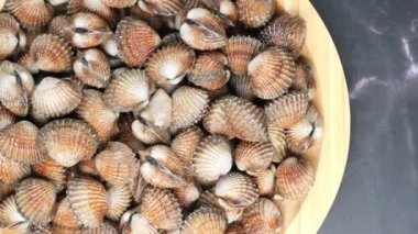dolly shot of cockles on a plate .