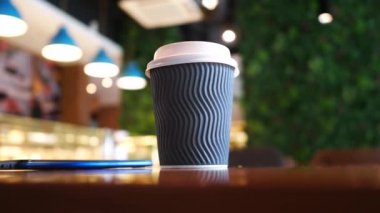 take away paper coffee cup o on cafe table ,