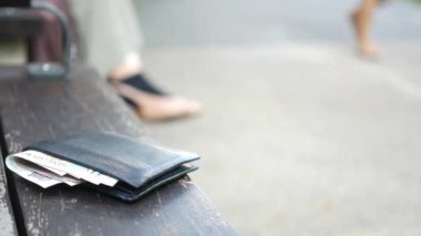  left wallet on a bench in the park ,
