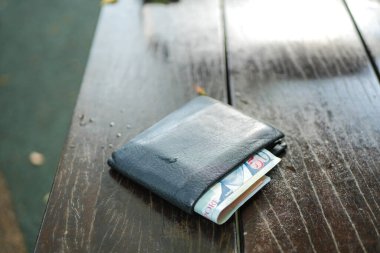  left wallet on a bench in the park ,
