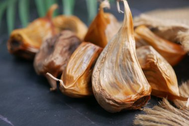 close up pf black garlic on white background table .
