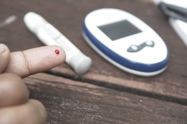 Delikanlılar evlerinde glikoz seviyesini elle ölçerler..