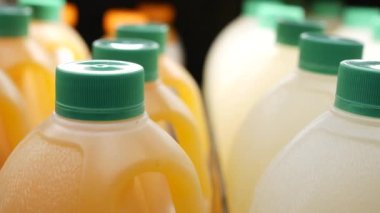 plastic bottle of orange juice in a shelf ,