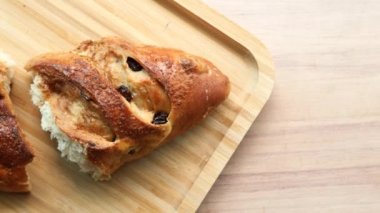 fresh baked brown sugar pillow raisin on table .