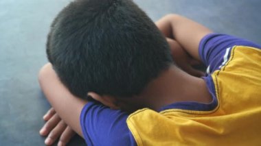 teenage boy head down on desk .