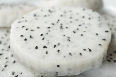 Bir dilim ejderha meyvesi doğrama tahtasında.,