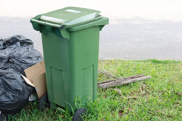 Bag with garbage and rubbish bin,