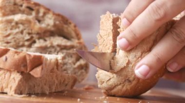 cutting baked brow bread on table