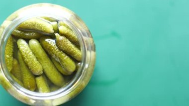  bottle of pickled cucumbers, pickles on table .