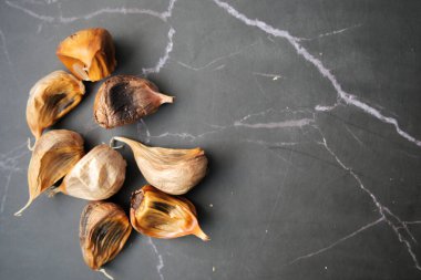 close up pf black garlic on white background table .
