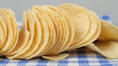 potato chips spilling form a packet on table ,