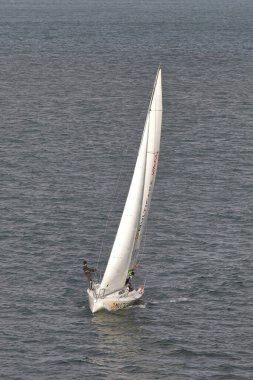 A yacht sails on the River Tagus off the Lisbon coastline in Portugual.  The yacht is endorsed by Multicare Vitality.