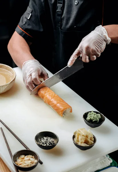 Cottura Chef Affettare Sushi Sulla Tavola Bianca Con Coltello Guanti Immagini Stock Royalty Free