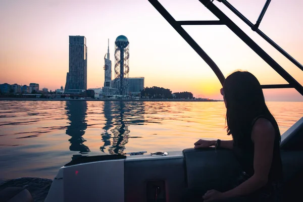Tourist Woman on boat tour enjoy summer sunset in Georgia resort- Batumi