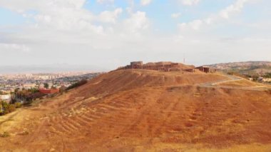 Yükselen hava manzaralı Erebuni kalesi, Erivan şehir panorama arka planına sahip tepede harabeler oluşturuyor. Eski bir urartian şehri. Ermenistan 'da önemli tarihi bir yer