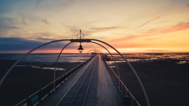 Southport pier panoramic view at sunset with scenic landscape and no people. Romantic travel destination United Kingdom clipart