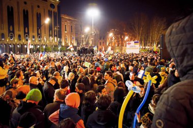 Tbilisi, Georgia - 1st march, 2022: : Hundreds of people stand for Ukrainian people against Russian troops attack and invasion on Ukraine clipart
