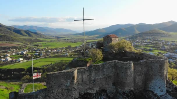 Aerial Static View Kveshi Fortress Georgian Flag Cross Top Spring — стокове відео